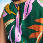 Close-up of round neckline and lightweight woven fabric on tropical print top
