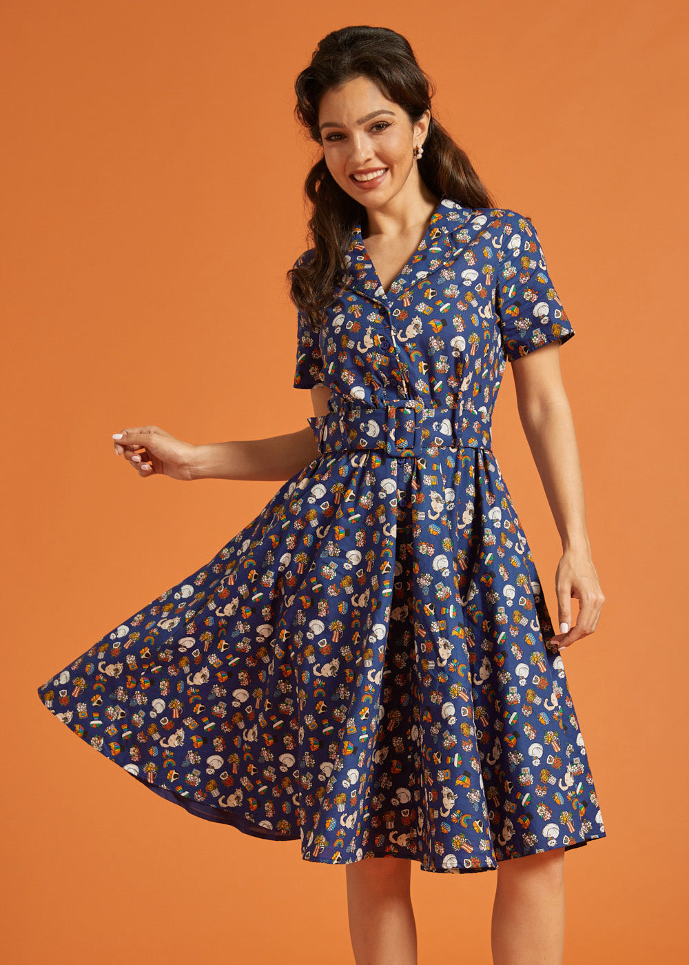 Woman wearing a blue quirky print dress with short sleeves