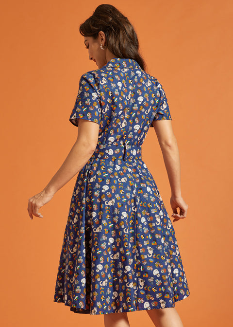 Back view of a woman wearing a blue vintage inspired fit and flare printed dress