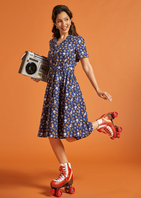 Woman in a retro dress with red roller skates and a boombox on an orange background