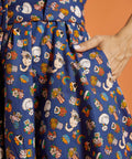 Close-up of a colorful dress with cat pattern showing side pocket detail