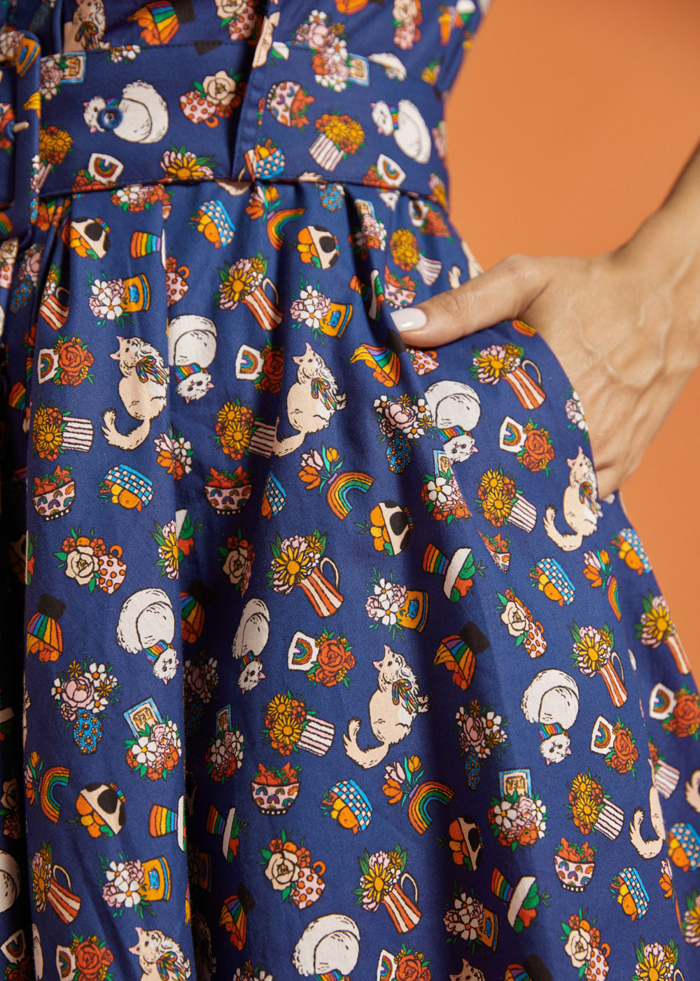 Close-up of a colorful dress with cat pattern showing side pocket detail