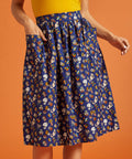 Woman wearing a blue patterned skirt with front patch pockets
