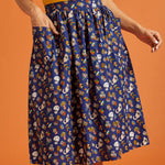 Woman wearing a blue patterned skirt with front patch pockets