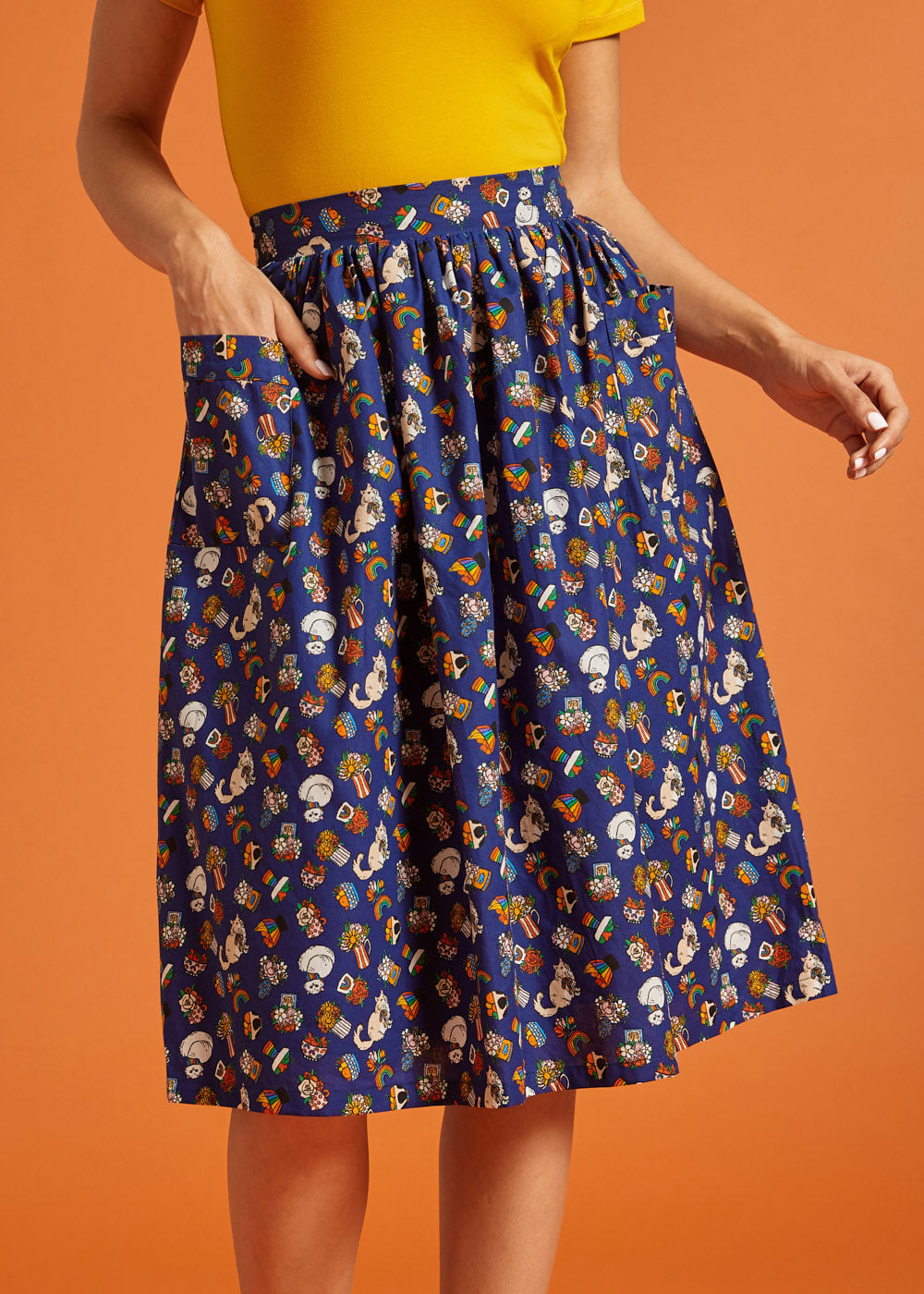 Woman wearing a blue patterned skirt with front patch pockets