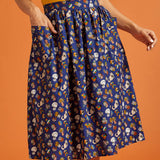 Woman wearing a blue patterned skirt with front patch pockets