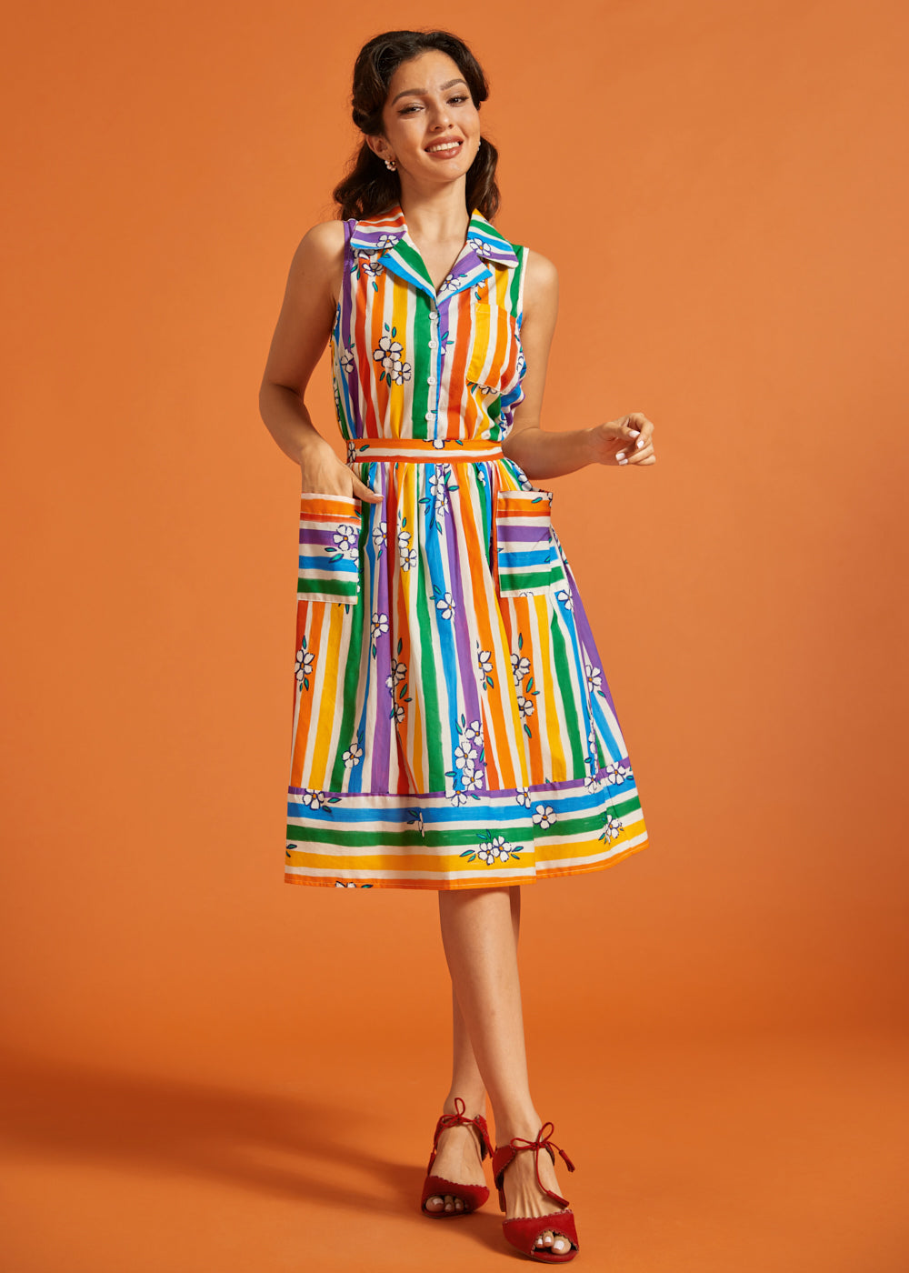 Woman wearing a colorful striped rainbow skirt with matching sleeveless blouse