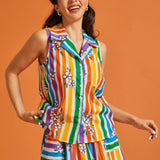 Woman wearing a colorful striped sleeveless cotton summer blouse and matching skirt set