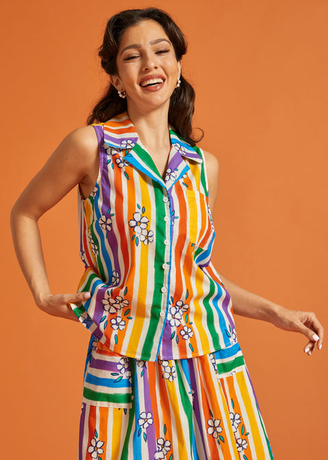 Woman wearing a colorful striped sleeveless cotton summer blouse and matching skirt set