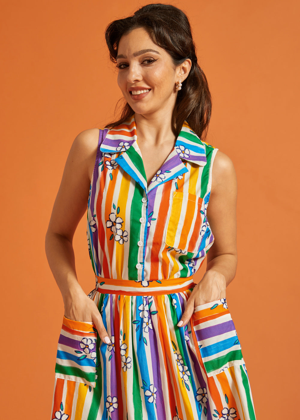 Woman wearing a colorful striped rainbow floral print summer top and skirt set