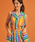 Woman wearing a colorful striped rainbow floral print summer top and skirt set