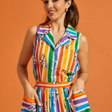 Woman wearing a colorful striped rainbow floral print summer top and skirt set