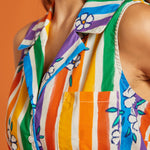 Close up of colorful striped shirt with floral patterns, chest pocket, and collar