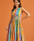 Woman wearing a colorful striped dress against an orange background