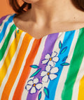 Close-up of a colorful striped dress with floral patterns