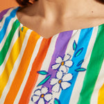 Close-up of a colorful striped dress with floral patterns