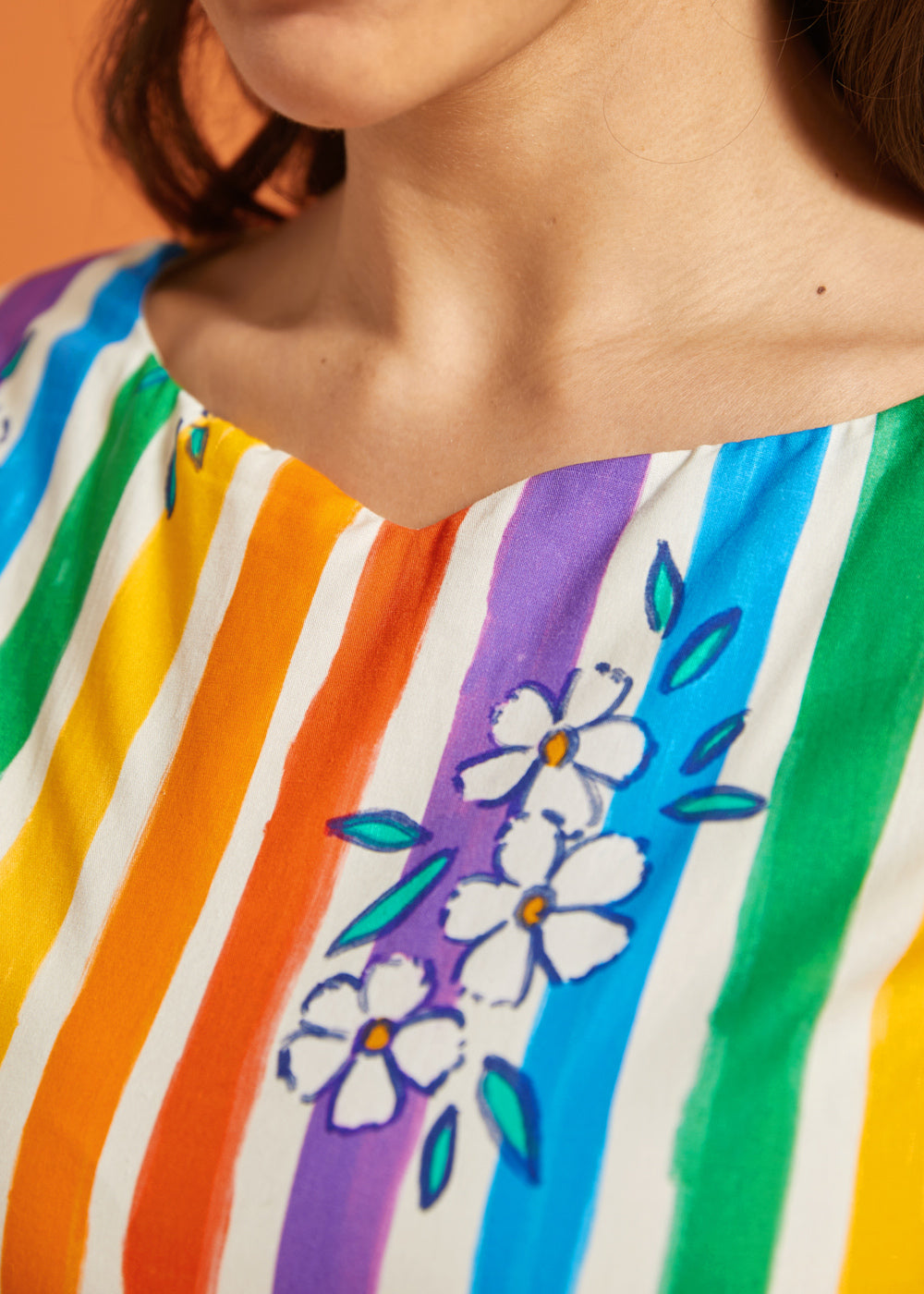 Close-up of a colorful striped dress with floral patterns