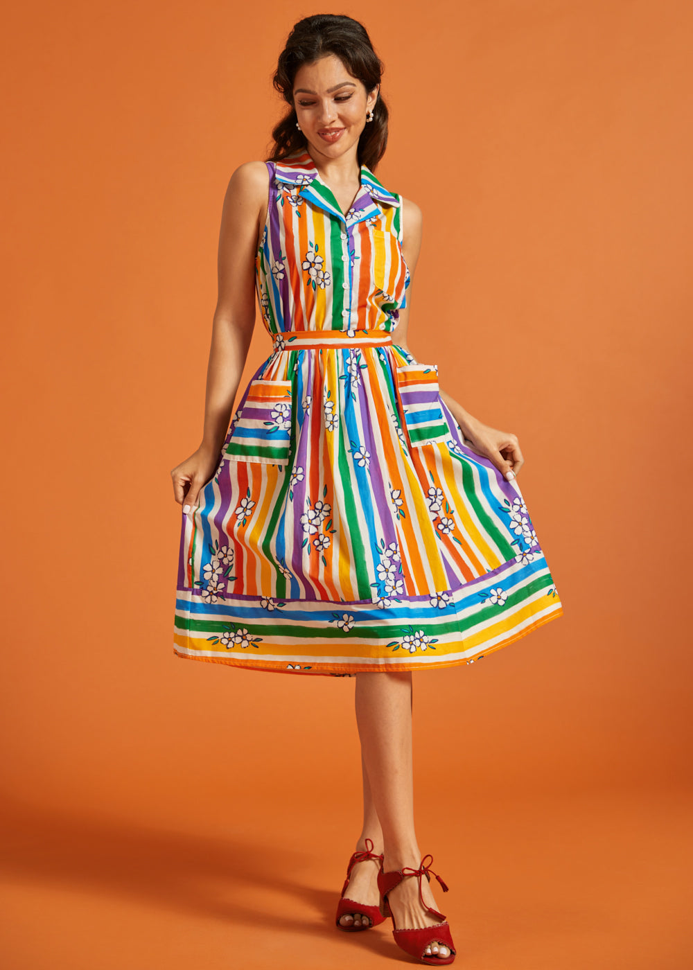 Woman wearing a rainbow striped skirt with matching colorful blouse