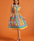 Woman wearing a rainbow striped skirt with matching colorful blouse
