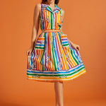 Woman wearing a rainbow striped skirt with matching colorful blouse