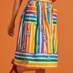 Colorful striped skirt with floral patterns on an orange background