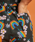 Close up back view of black shorts with rainbow and flower pattern and back pocket