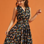 Woman wearing a vintage inspired black dress with rainbow and floral pattern