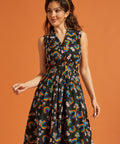 Woman wearing a black dress with colorful rainbow patterns for Pride
