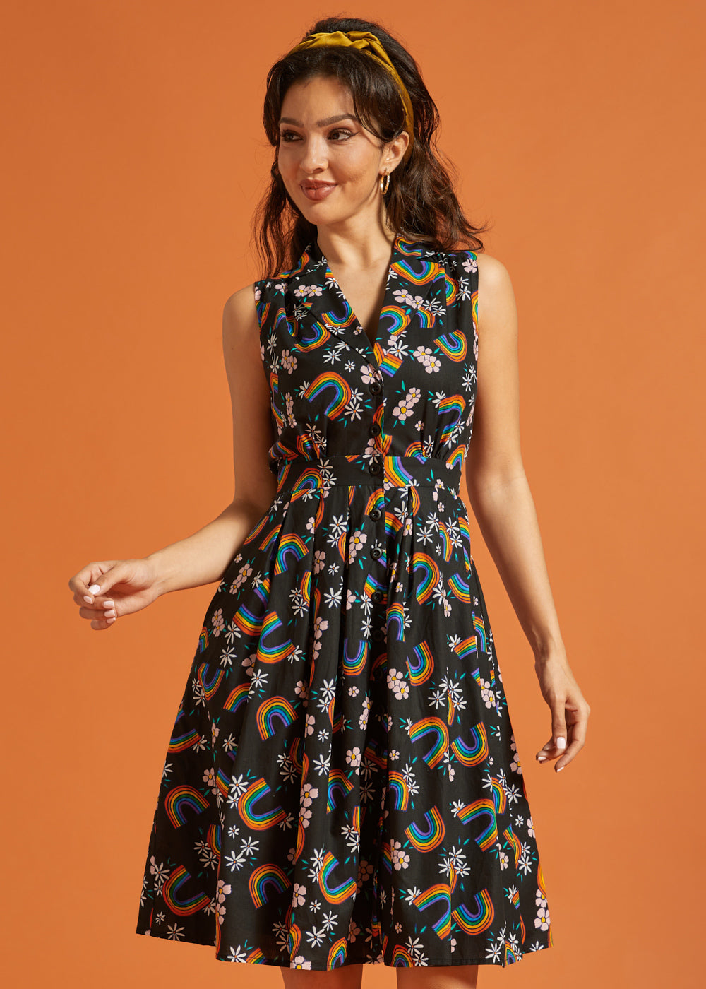 Woman wearing a black dress with colorful rainbow patterns for Pride