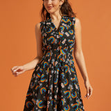 Woman wearing a black dress with colorful rainbow patterns for Pride
