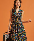 Woman wearing a sleeveless dress with rainbow pattern, holding a retro boombox