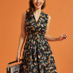 Woman wearing a sleeveless dress with rainbow pattern, holding a retro boombox