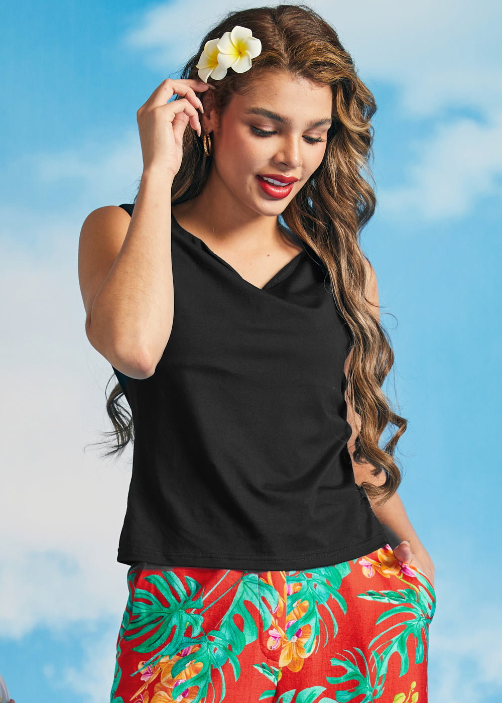 Woman modeling a black stretch knit sleeveless top with a soft boatneck neckline