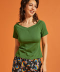 Woman wearing a solid green retro style t-shirt with a boat neck