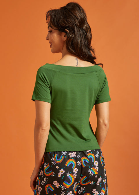 Back view of a woman wearing a green top with short sleeves