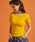 Woman wearing a yellow short sleeve top