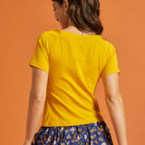 Back view of a woman wearing a solid yellow shirt