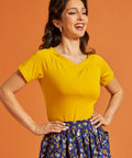 Woman wearing a yellow top with short sleeves