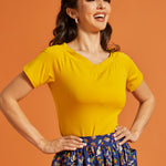 Woman wearing a yellow top with short sleeves