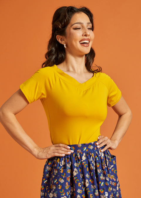 Woman wearing a yellow top with short sleeves