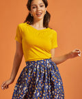 Woman wearing a retro style marigold yellow tee