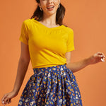 Woman wearing a retro style marigold yellow tee