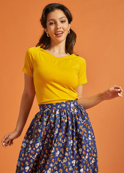 Woman wearing a retro style marigold yellow tee