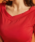 Close-up of a woman wearing a solid red boat neck tee