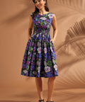 Woman wearing a vintage-inspired floral fit-and-flare midi dress with pockets
