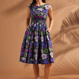 Woman wearing a vintage-inspired floral fit-and-flare midi dress with pockets