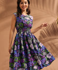 Woman twirling in a black floral midi dress with cap sleeves