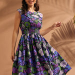 Woman twirling in a black floral midi dress with cap sleeves