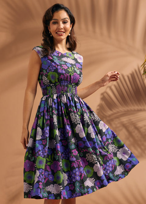 Woman twirling in a black floral midi dress with cap sleeves