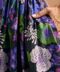 Detail of side pocket on black floral cotton midi dress